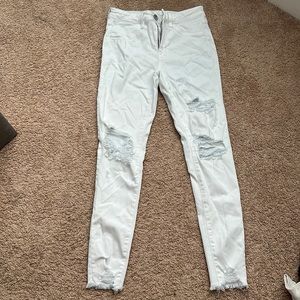 All White Jeans with holes in them